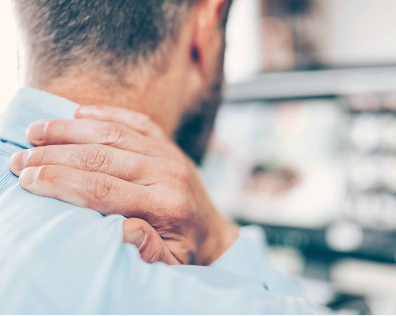 Man holding his neck in pain