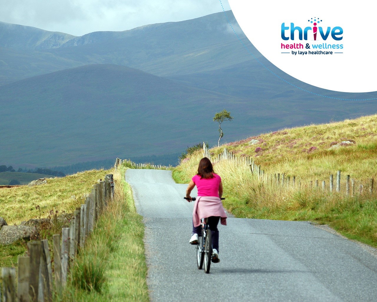 woman cycling a bike in the mountains