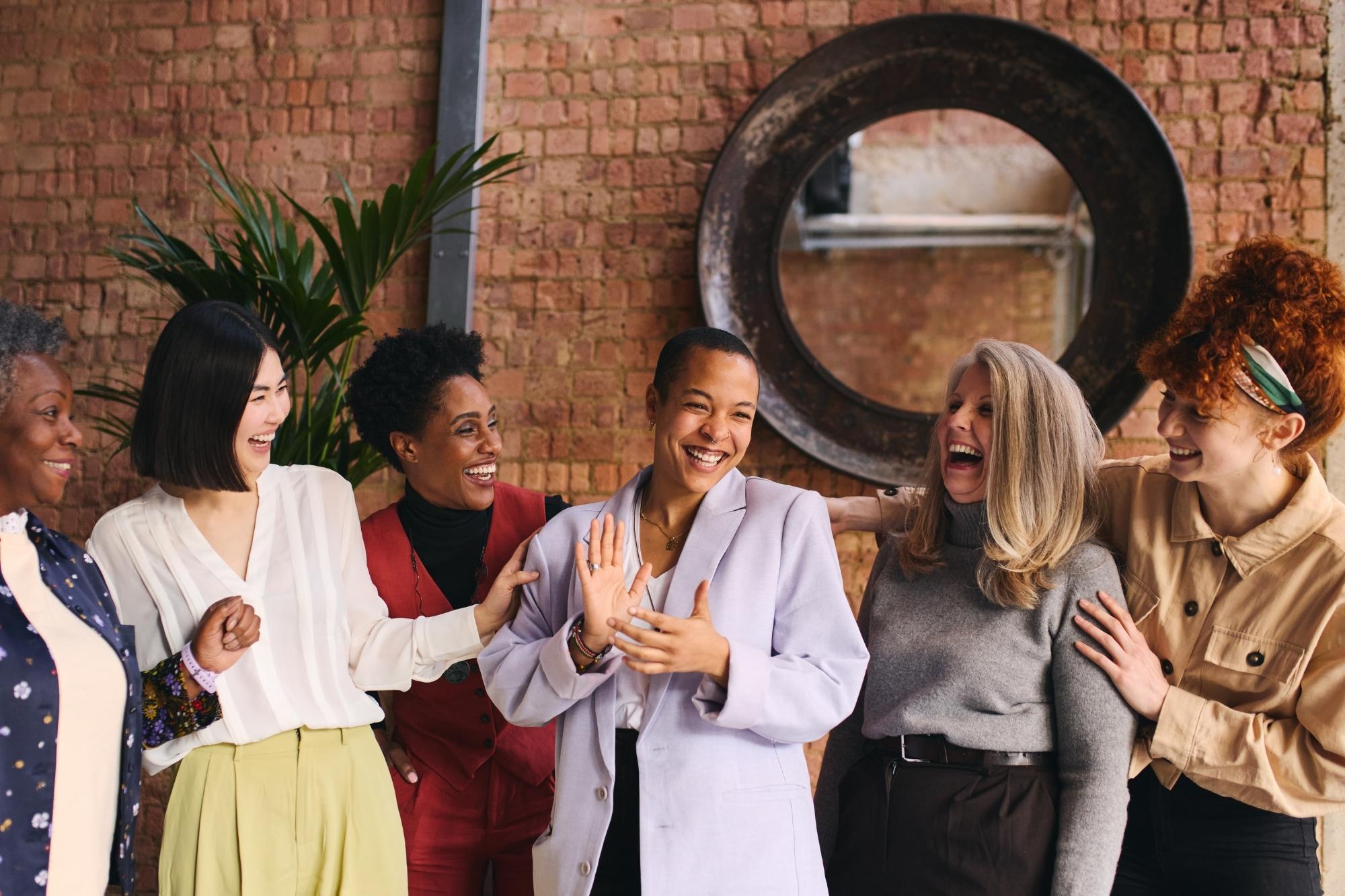 A group of women of different ages and races smiling